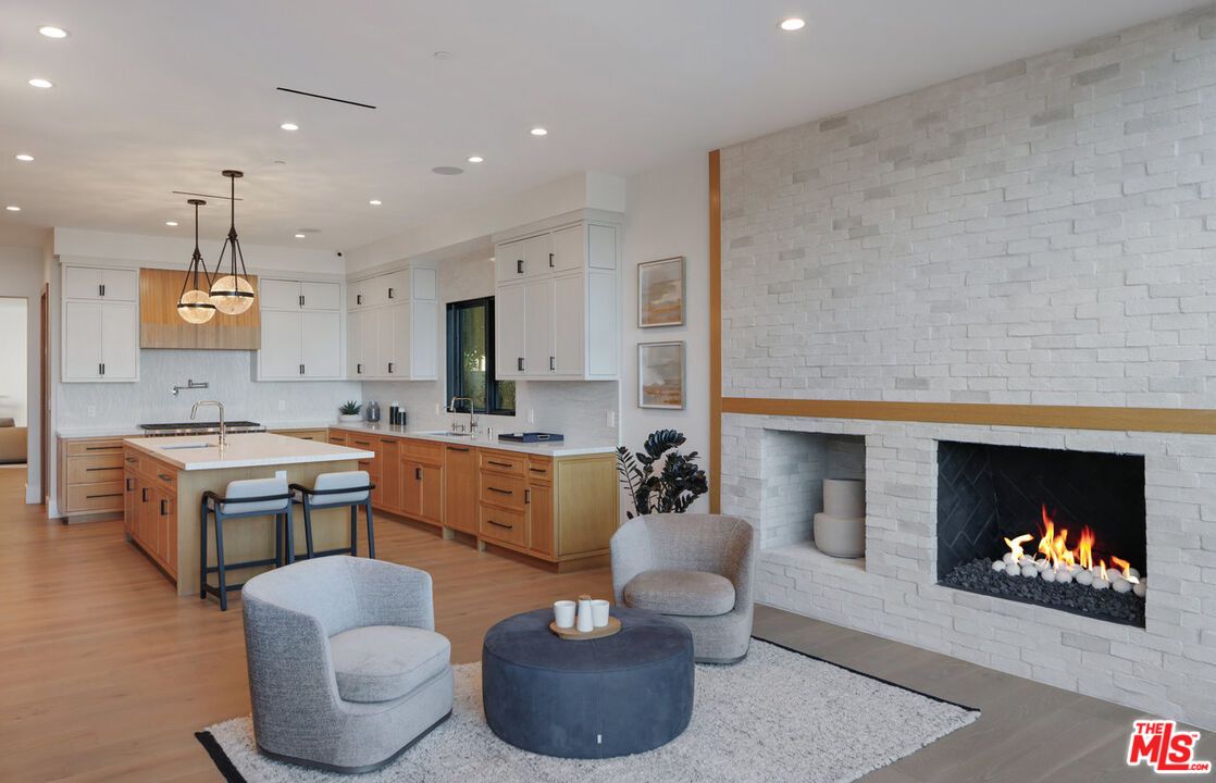 Fireplace, Interior, Kitchen, Pendant Lights, Recessed Lighting, Stainless Steel Appliances, Stone Walls, Wood Texture Flooring