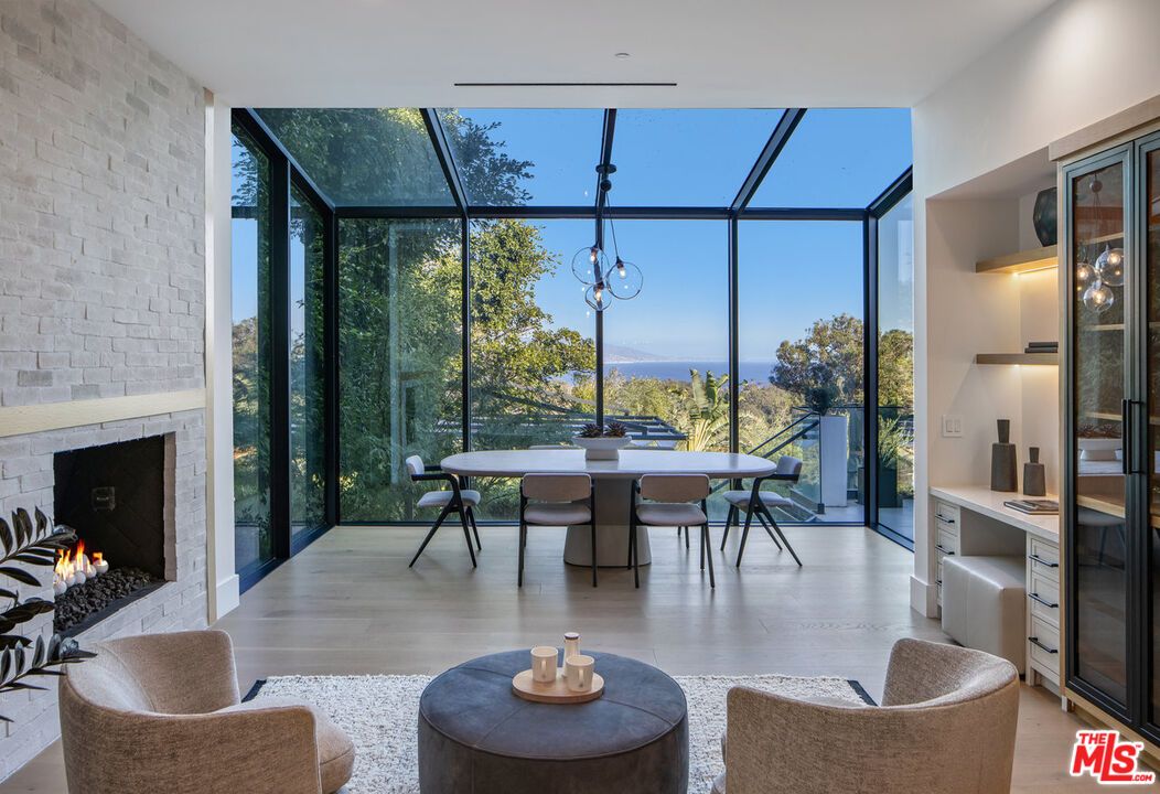 Dining room, Fireplace, Glass Ceilings, Interior, Pendant Lights, Stone Walls, Sun Room, Water, Wood Texture Flooring