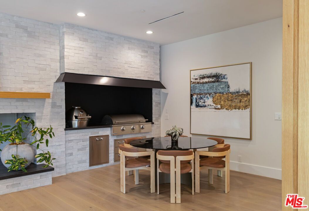 Dining room, Fireplace, Interior, Recessed Lighting, Stone Walls, Wood Texture Flooring