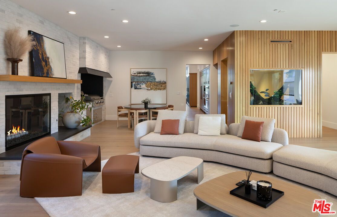 Dining room, Fireplace, Interior, Living room, Recessed Lighting, Stone Walls, Wood Texture Flooring