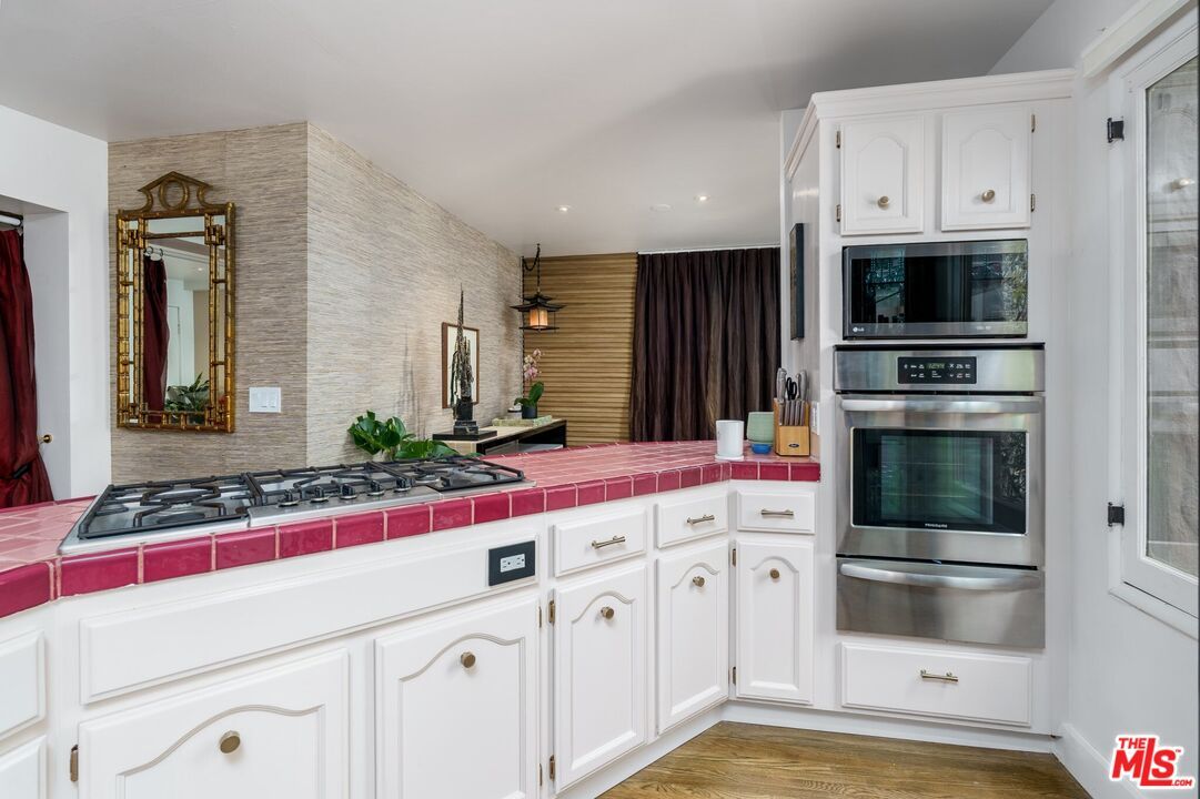 Interior, Kitchen, Pendant Lights, Recessed Lighting, Stainless Steel Appliances, Tile Countertops, Wood Texture Flooring