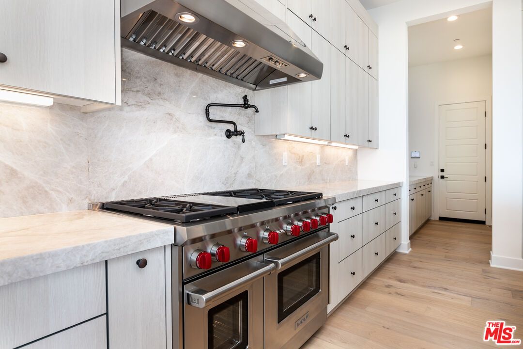 Interior, Kitchen, Marble Walls, Recessed Lighting, Stainless Steel Appliances, Wood Texture Flooring