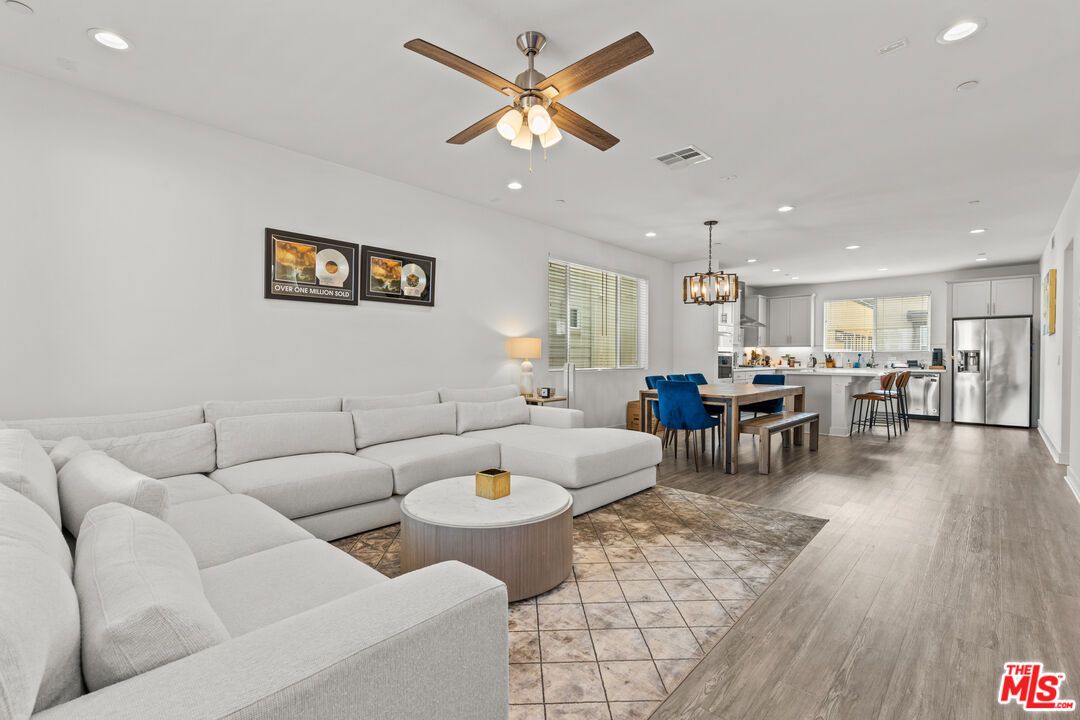 Chandelier, Dining room, Interior, Kitchen, Living room, Pendant Lights, Recessed Lighting, Stainless Steel Appliances, Wood Texture Flooring