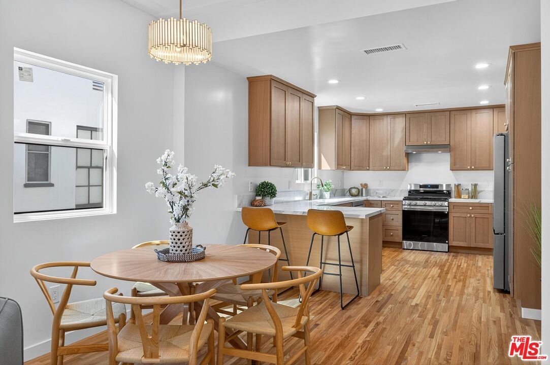Dining room, Interior, Kitchen, Pendant Lights, Recessed Lighting, Stainless Steel Appliances, Wood Texture Flooring