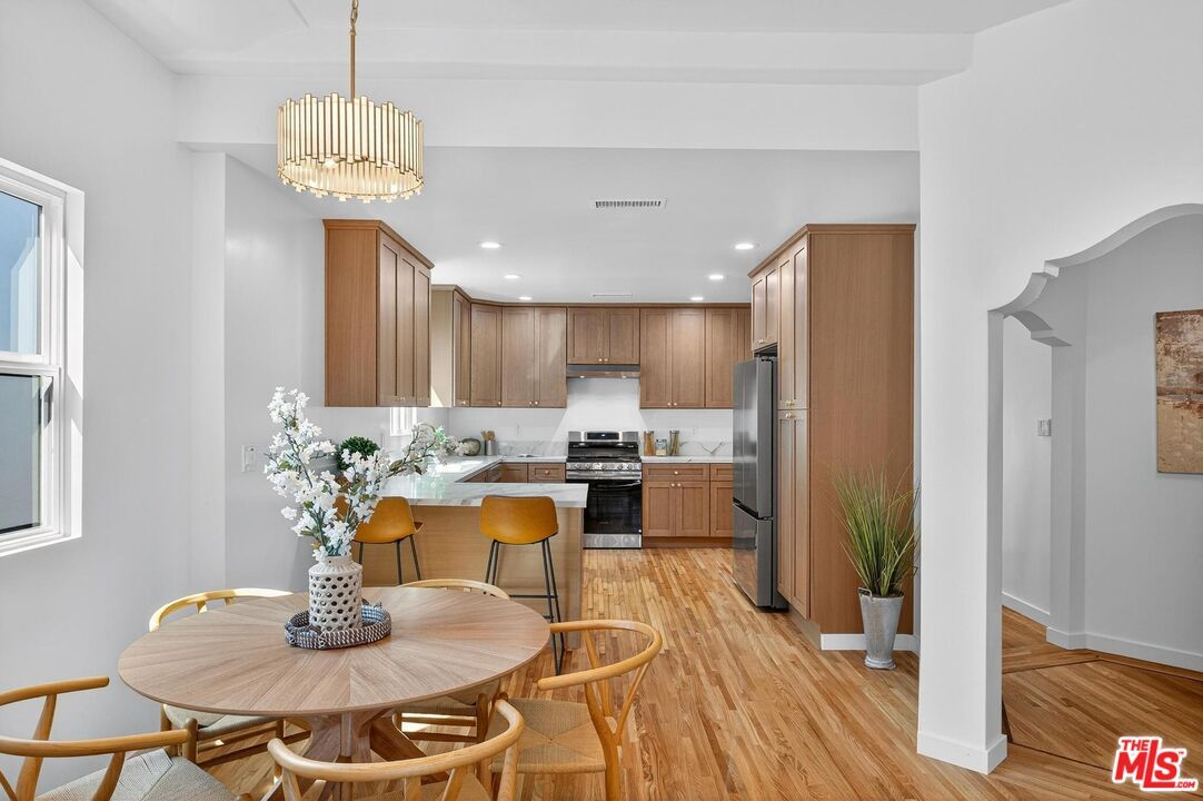 Chandelier, Dining room, Interior, Kitchen, Pendant Lights, Recessed Lighting, Stainless Steel Appliances, Wood Texture Flooring