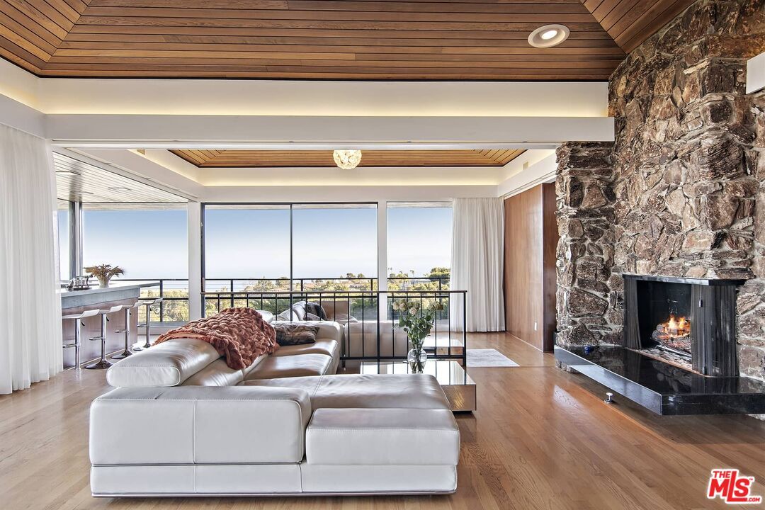 Fireplace, Interior, Living room, Recessed Lighting, Stone Walls, Water, Wooden Ceilings, Wood Texture Flooring