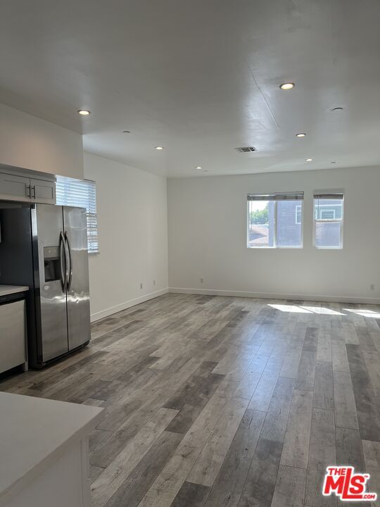 Empty room, Interior, Kitchen, Recessed Lighting, Stainless Steel Appliances, Wood Texture Flooring