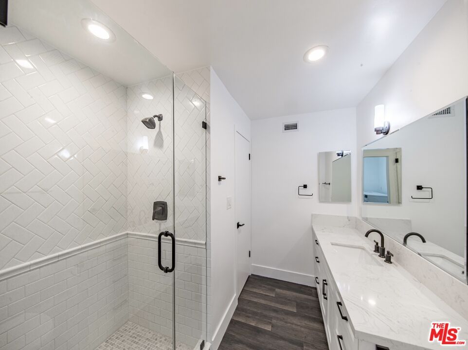 Bathroom, Dual Sink Vanities, Glass Shower, Interior, Recessed Lighting, Wood Texture Flooring