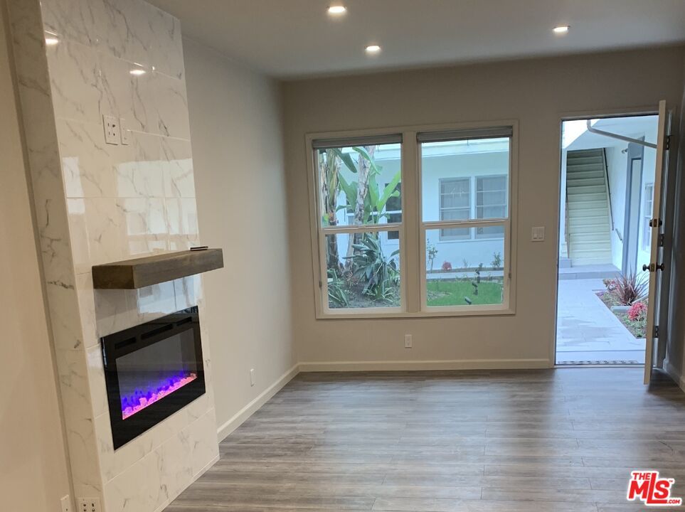 Empty room, Fireplace, Interior, Marble Walls, Recessed Lighting, Wood Texture Flooring