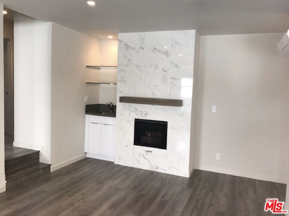 Fireplace, Interior, Marble Walls, Recessed Lighting, Wood Texture Flooring