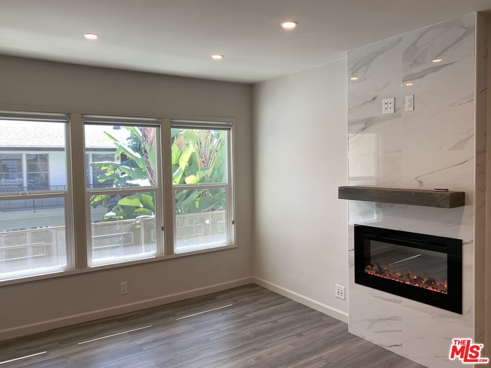 Empty room, Fireplace, Interior, Marble Walls, Recessed Lighting, Wood Texture Flooring