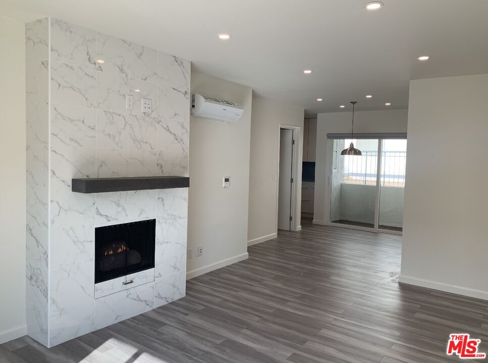 Fireplace, Interior, Marble Walls, Pendant Lights, Recessed Lighting, Wood Texture Flooring