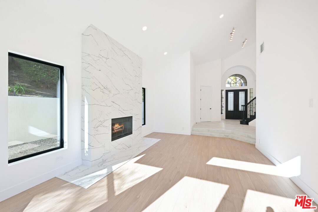 Empty room, Fireplace, Interior, Marble Walls, Recessed Lighting, Wood Texture Flooring