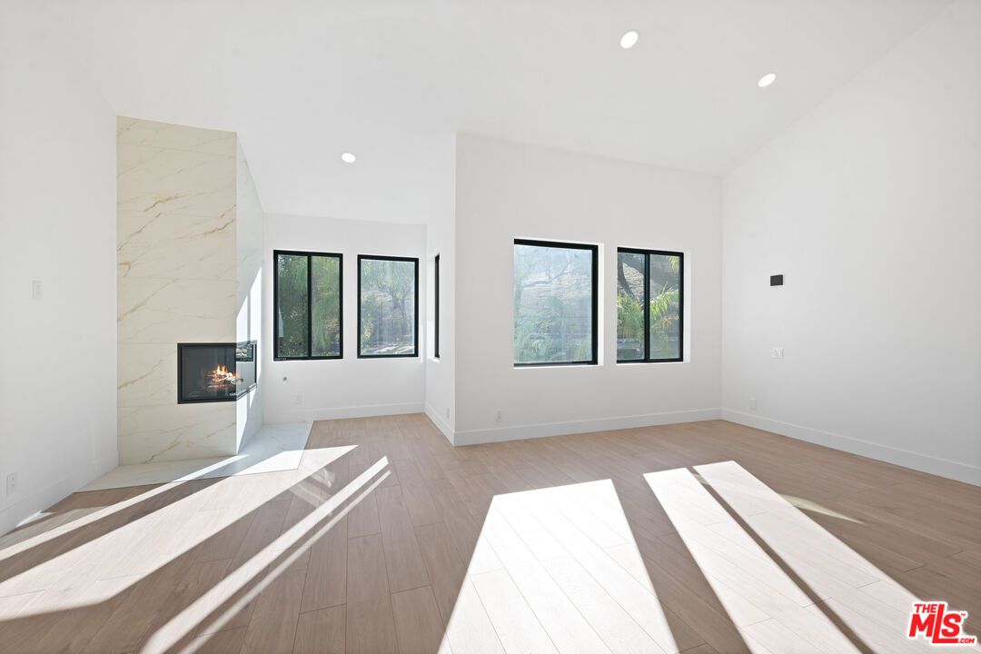 Empty room, Fireplace, Interior, Marble Walls, Recessed Lighting, Wood Texture Flooring