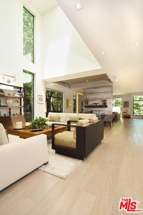 Dining room, Fireplace, Interior, Living room, Recessed Lighting, Stone Walls, Wood Texture Flooring