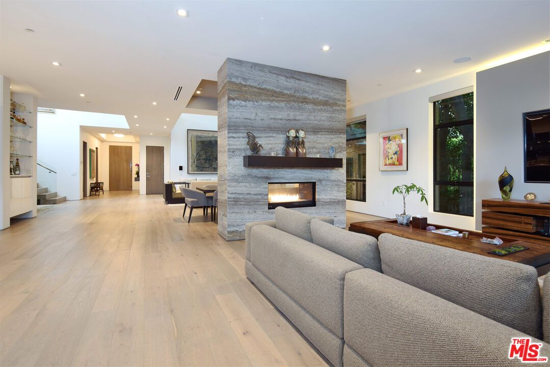 Dining room, Fireplace, Interior, Living room, Recessed Lighting, Stone Walls, Wood Texture Flooring