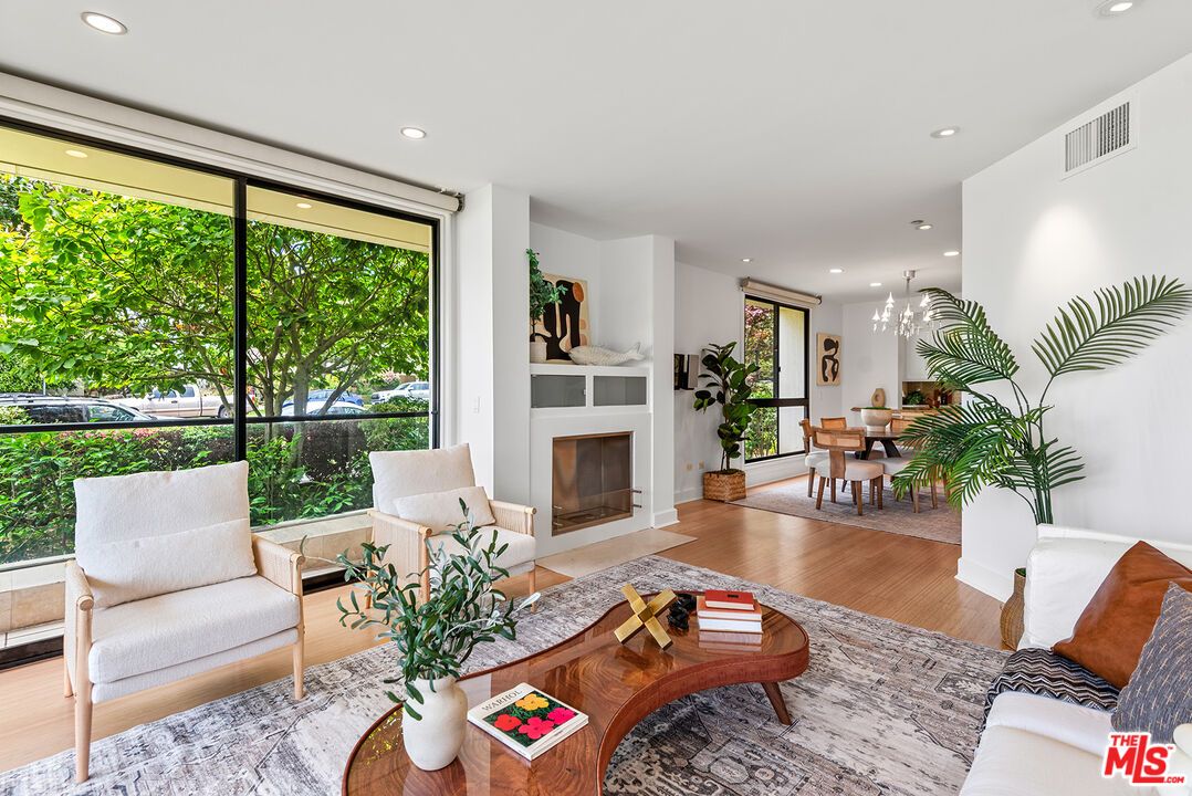 Chandelier, Dining room, Fireplace, Interior, Living room, Pendant Lights, Recessed Lighting, Wood Texture Flooring