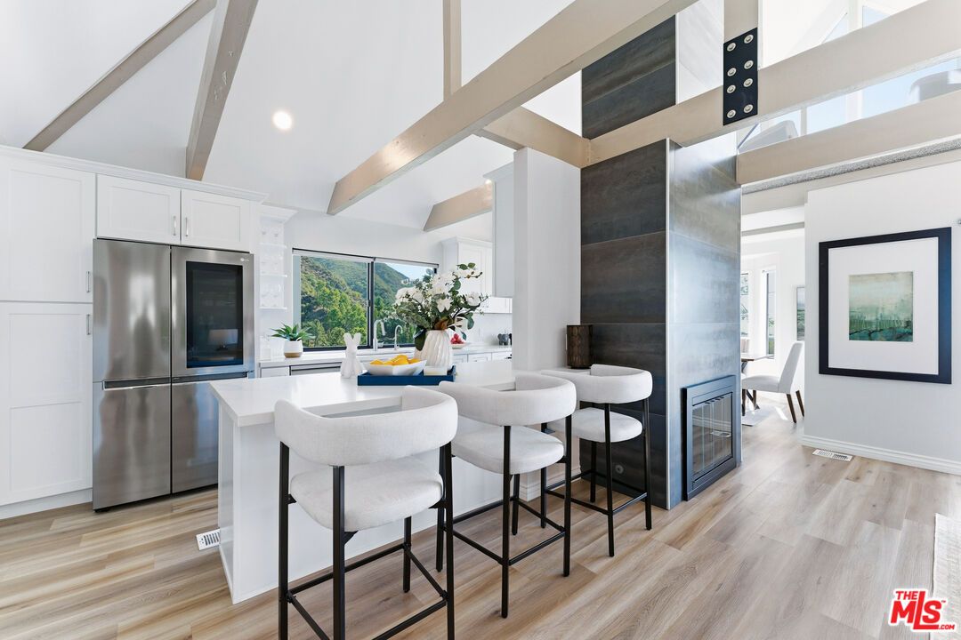 Dining room, Fireplace, Interior, Kitchen, Recessed Lighting, Stainless Steel Appliances, Wood Texture Flooring