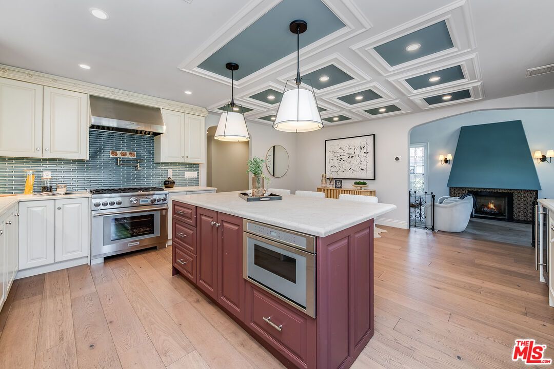 Fireplace, Interior, Kitchen, Living room, Pendant Lights, Recessed Lighting, Stainless Steel Appliances, Wood Texture Flooring