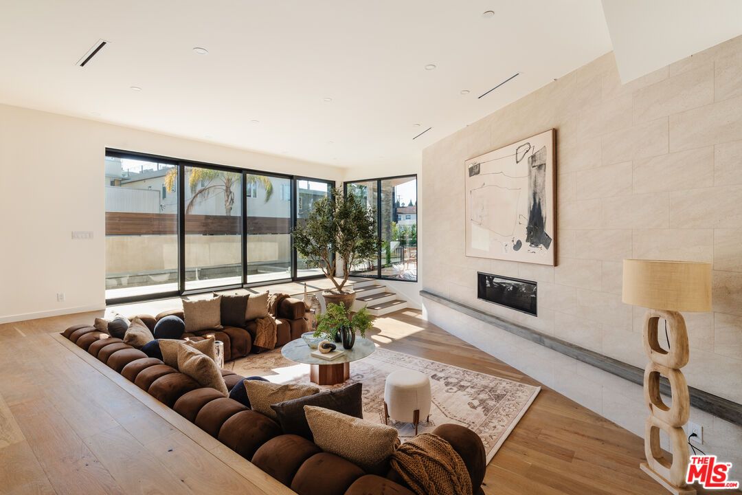 Fireplace, Interior, Living room, Recessed Lighting, Stone Walls, Wood Texture Flooring