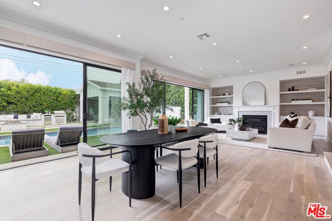 Dining room, Fireplace, Interior, Living room, Recessed Lighting, Wood Texture Flooring