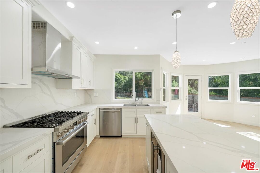 Interior, Kitchen, Marble Walls, Pendant Lights, Recessed Lighting, Stainless Steel Appliances, Wood Texture Flooring
