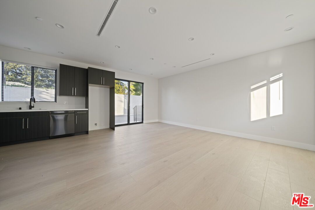 Empty room, Interior, Kitchen, Recessed Lighting, Stainless Steel Appliances, Wood Texture Flooring