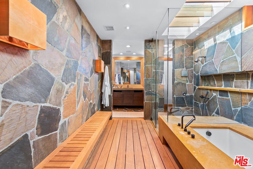 Bathroom, Dual Sink Vanities, Glass Shower, Interior, Recessed Lighting, Stone Walls, Wood Texture Flooring