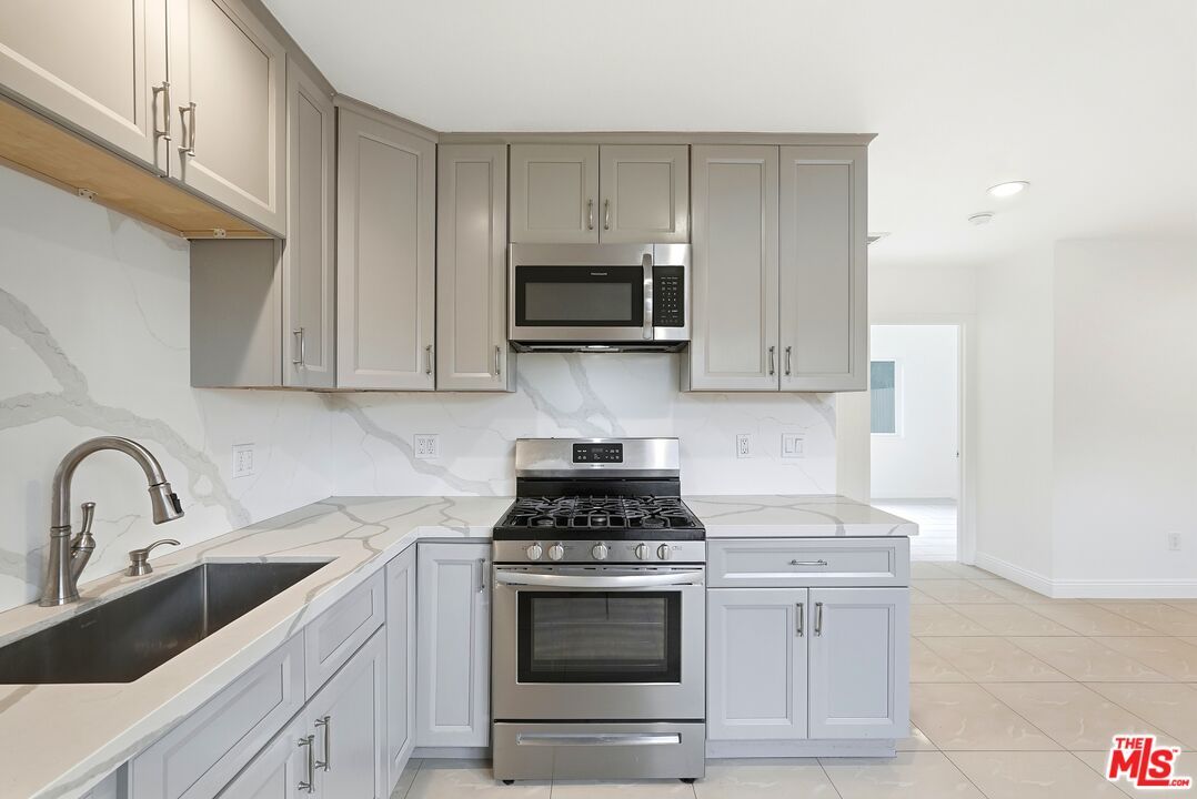 Interior, Kitchen, Marble Walls, Recessed Lighting, Stainless Steel Appliances