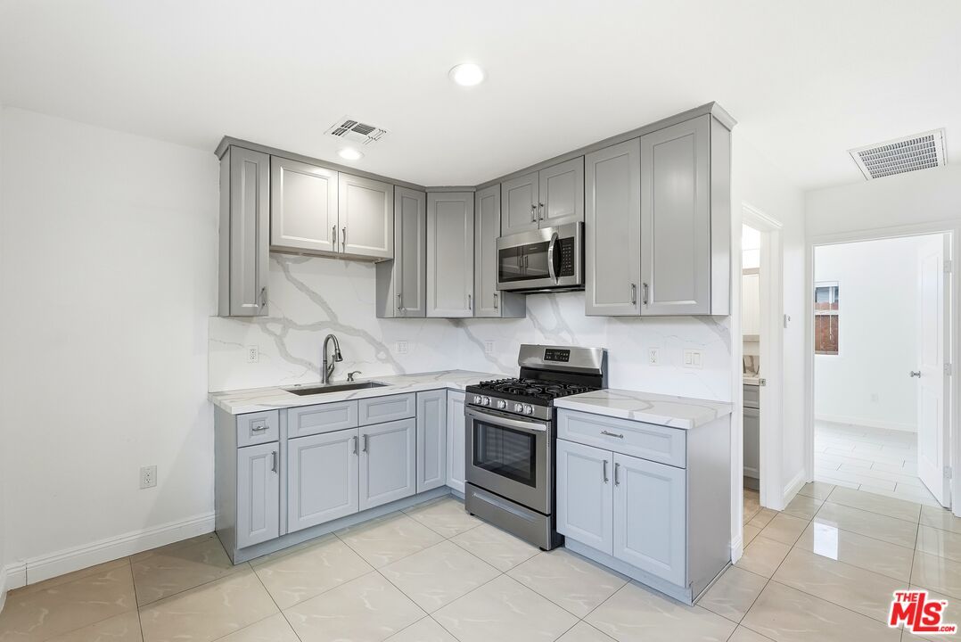 Interior, Kitchen, Marble Walls, Recessed Lighting, Stainless Steel Appliances