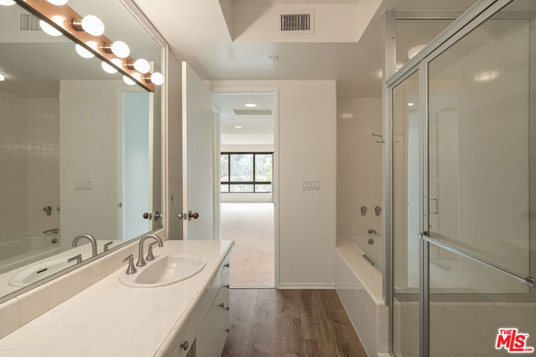 Bathroom, Dual Sink Vanities, Glass Shower, Interior, Recessed Lighting, Tile Countertops, Wood Texture Flooring
