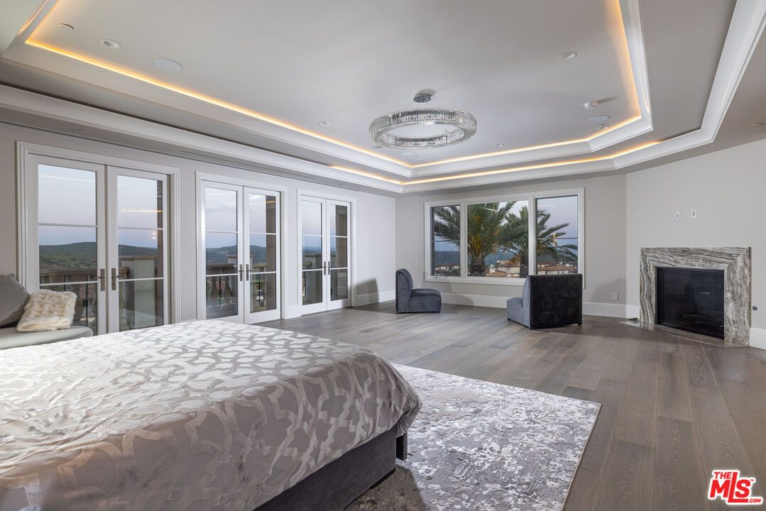 Bedroom, Chandelier, Fireplace, Interior, Recessed Lighting, Water, Wood Texture Flooring