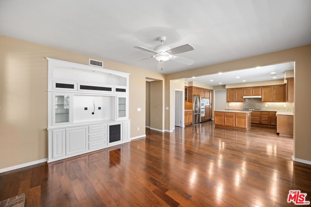 Empty room, Interior, Kitchen, Recessed Lighting, Stainless Steel Appliances, Wood Texture Flooring