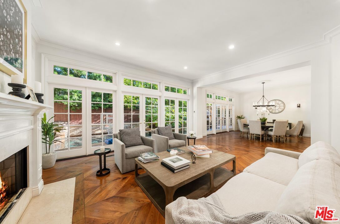 Chandelier, Dining room, Fireplace, Interior, Living room, Pendant Lights, Recessed Lighting, Wood Texture Flooring