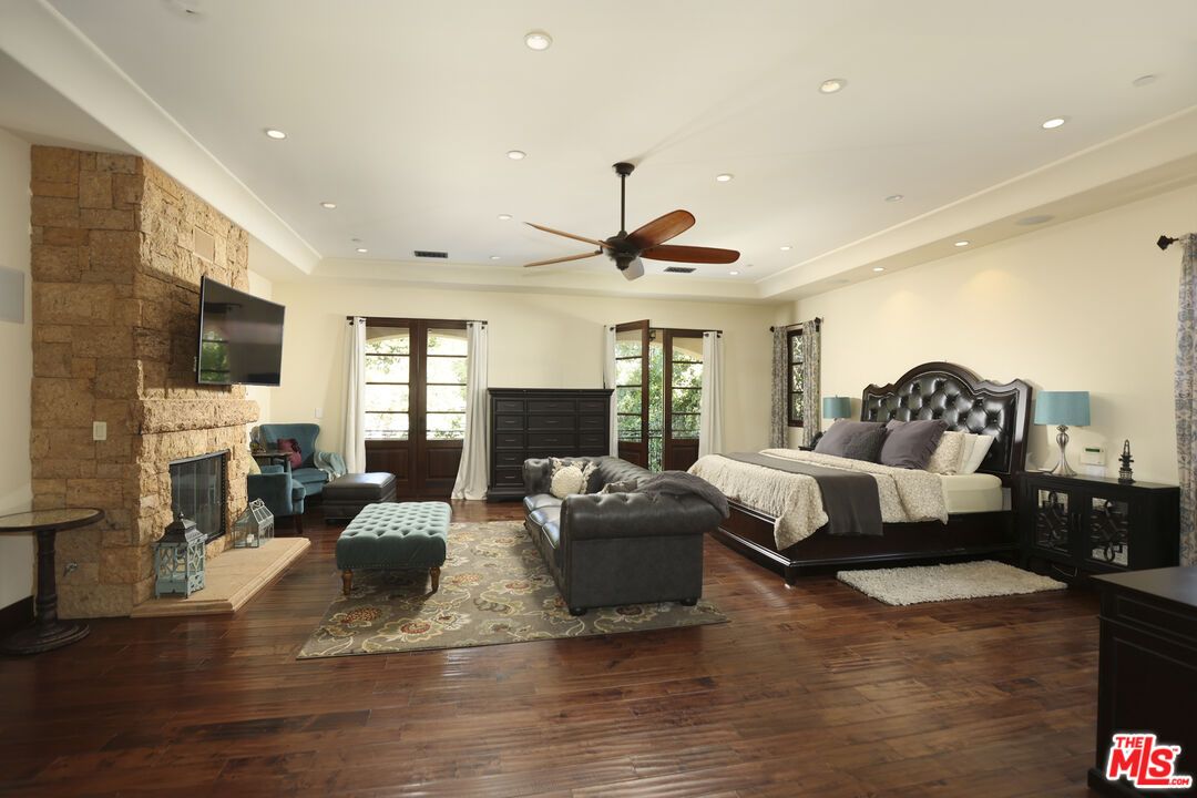 Bedroom, Fireplace, Interior, Recessed Lighting, Stone Walls, Wood Texture Flooring