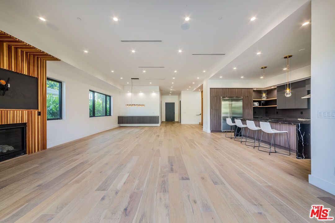 Empty room, Fireplace, Interior, Kitchen, Pendant Lights, Recessed Lighting, Wood Texture Flooring