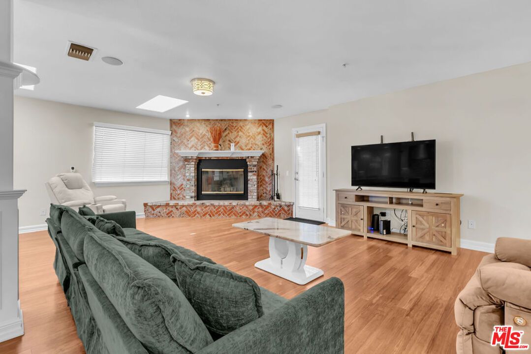 Fireplace, Interior, Living room, Recessed Lighting, Stone Walls, Wood Texture Flooring