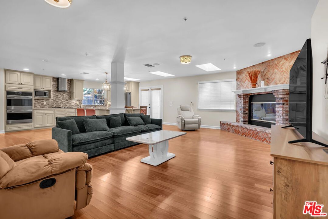 Fireplace, Interior, Kitchen, Living room, Pendant Lights, Recessed Lighting, Stainless Steel Appliances, Wood Texture Flooring