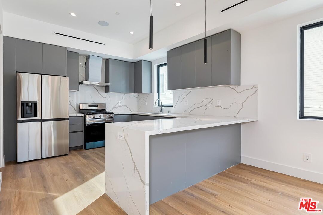 Interior, Kitchen, Marble Walls, Recessed Lighting, Stainless Steel Appliances, Wood Texture Flooring