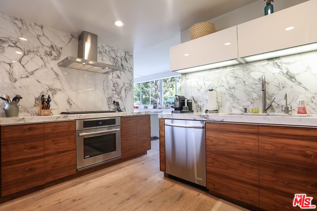Interior, Kitchen, Marble Walls, Recessed Lighting, Stainless Steel Appliances, Wood Texture Flooring