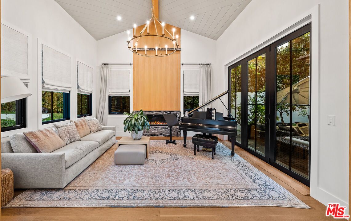 Chandelier, Fireplace, Interior, Living room, Piano, Recessed Lighting, Wood Texture Flooring