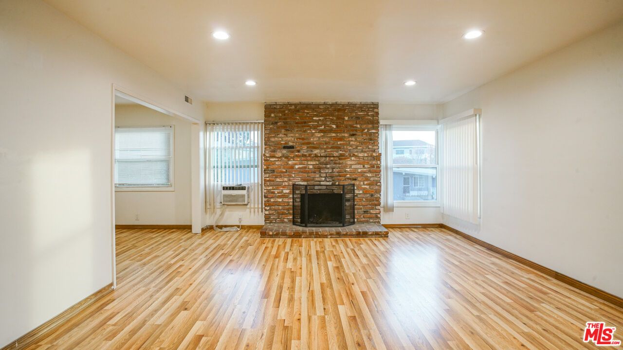 Empty room, Fireplace, Interior, Recessed Lighting, Stone Walls, Wood Texture Flooring