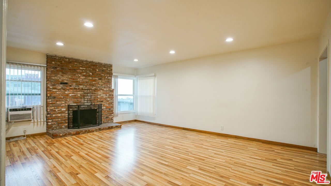 Empty room, Fireplace, Interior, Recessed Lighting, Stone Walls, Wood Texture Flooring