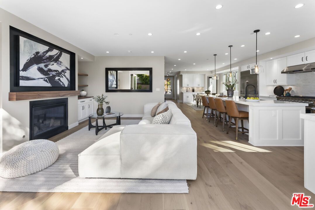 Fireplace, Interior, Kitchen, Living room, Pendant Lights, Recessed Lighting, Stainless Steel Appliances, Wood Texture Flooring