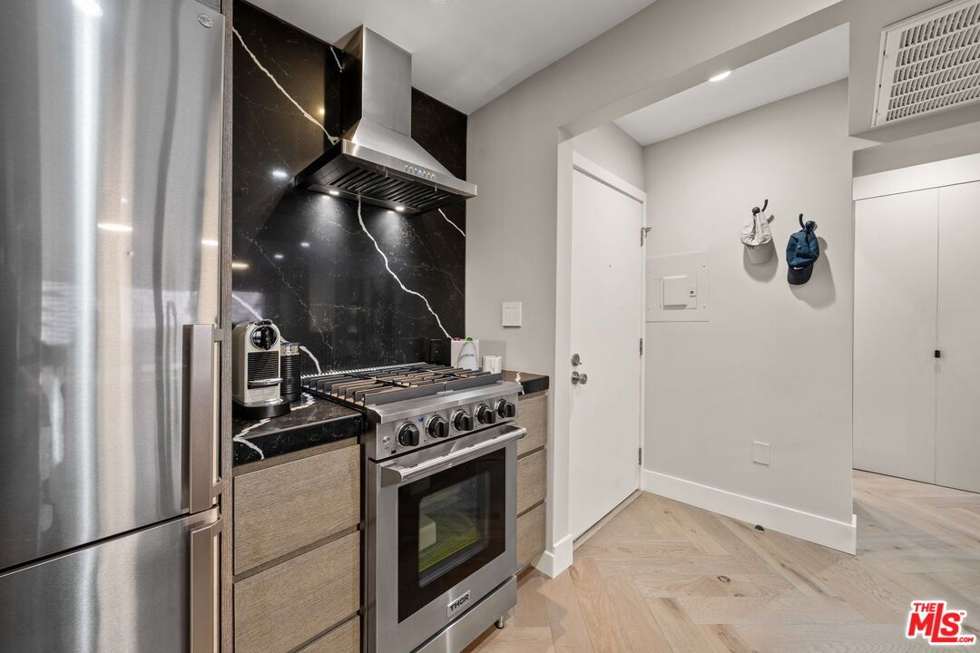 Interior, Kitchen, Marble Walls, Recessed Lighting, Stainless Steel Appliances, Wood Texture Flooring