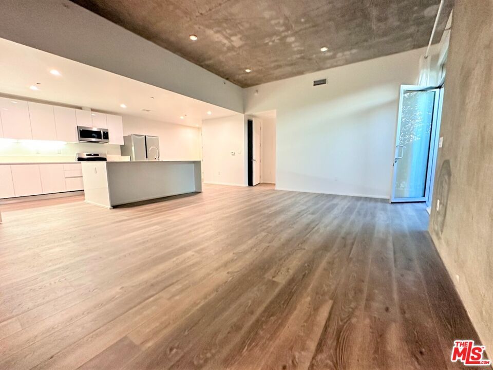 Empty room, Interior, Kitchen, Recessed Lighting, Stainless Steel Appliances, Wood Texture Flooring