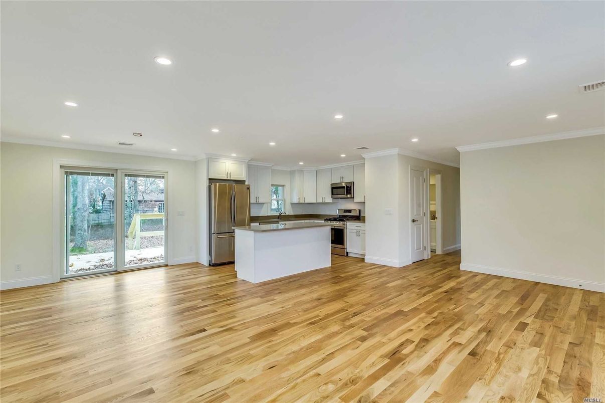 Empty room, Interior, Kitchen, Recessed Lighting, Stainless Steel Appliances, Wood Texture Flooring