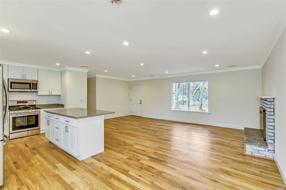 Empty room, Interior, Kitchen, Recessed Lighting, Stainless Steel Appliances, Wood Texture Flooring