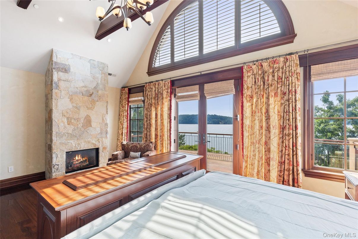 Bedroom, Fireplace, Interior, Recessed Lighting, Stone Walls, Water, Wood Texture Flooring