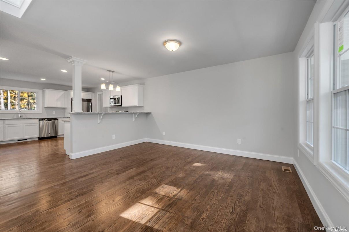 Empty room, Interior, Kitchen, Pendant Lights, Recessed Lighting, Stainless Steel Appliances, Wood Texture Flooring